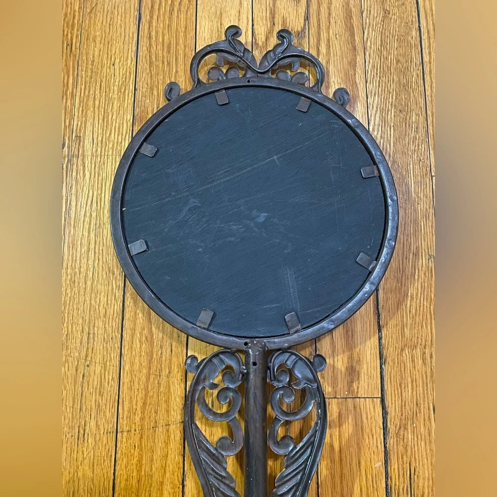 Vintage, ornate mirror with wooden backing